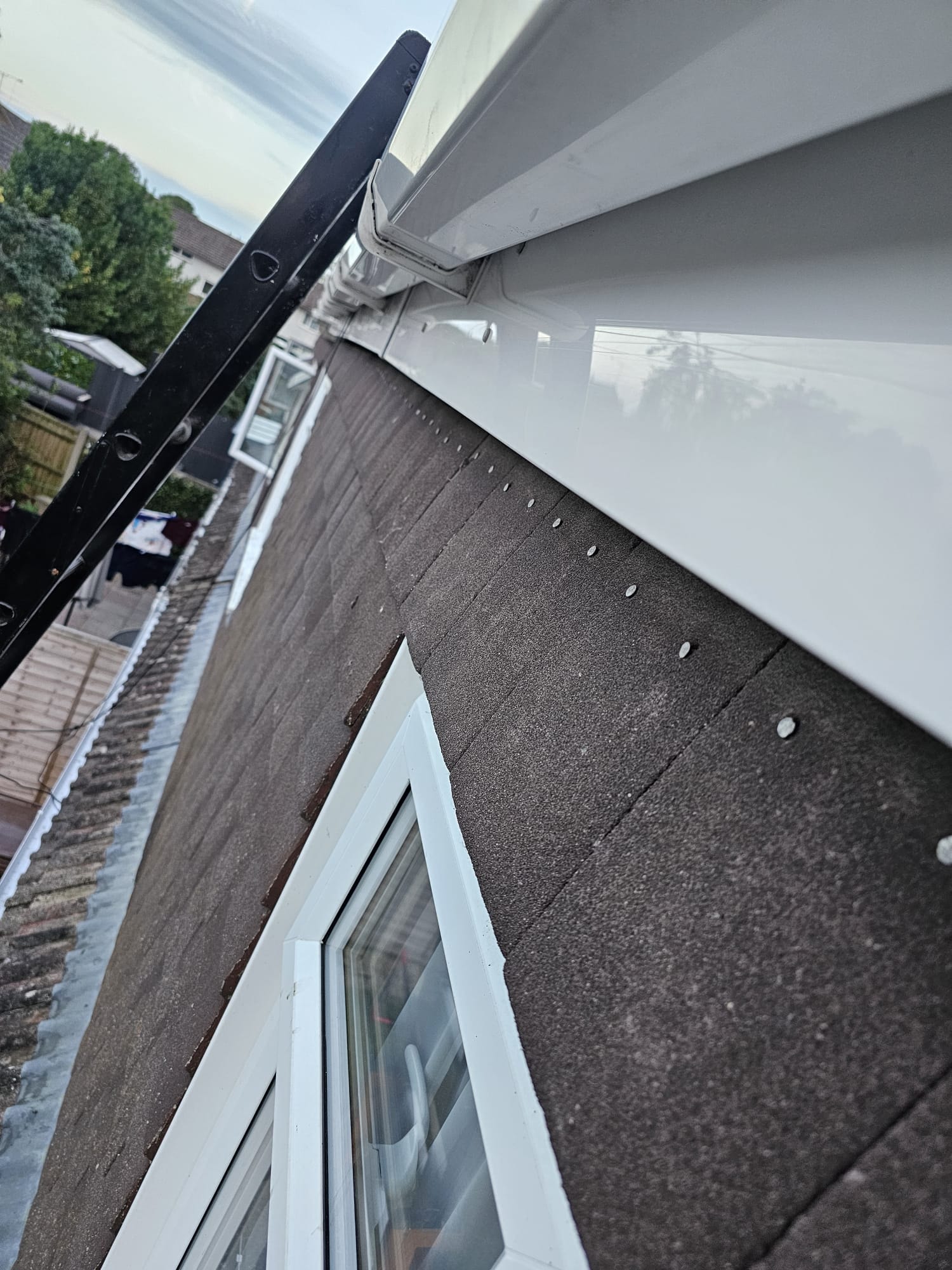 New white uPVC soffit and black guttering — close-up detail