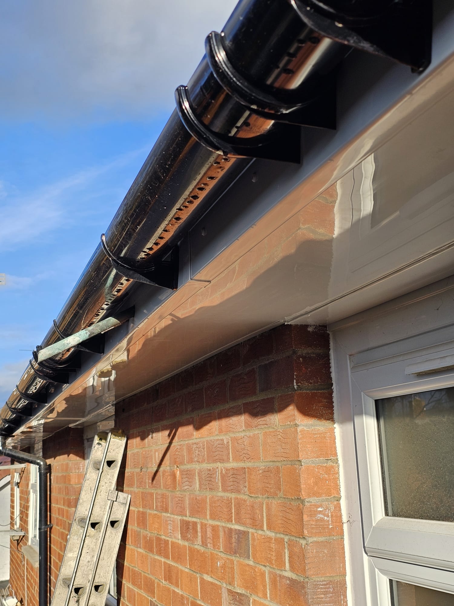 New white uPVC soffit with black guttering completed