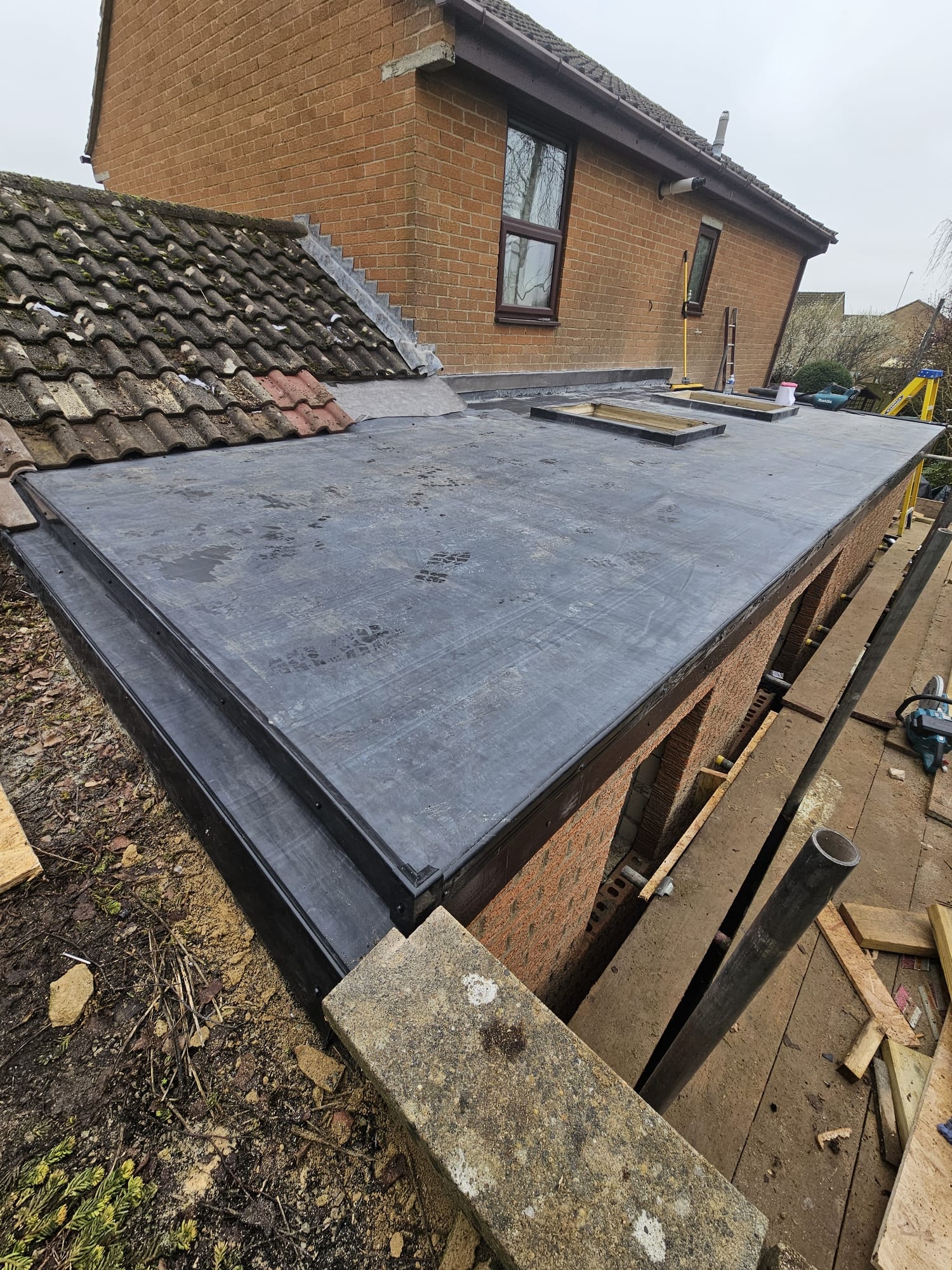 EPDM rubber flat roof on residential extension with rooflight