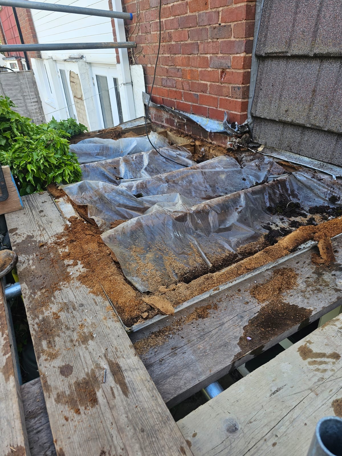Failed flat roof stripped back before replacement