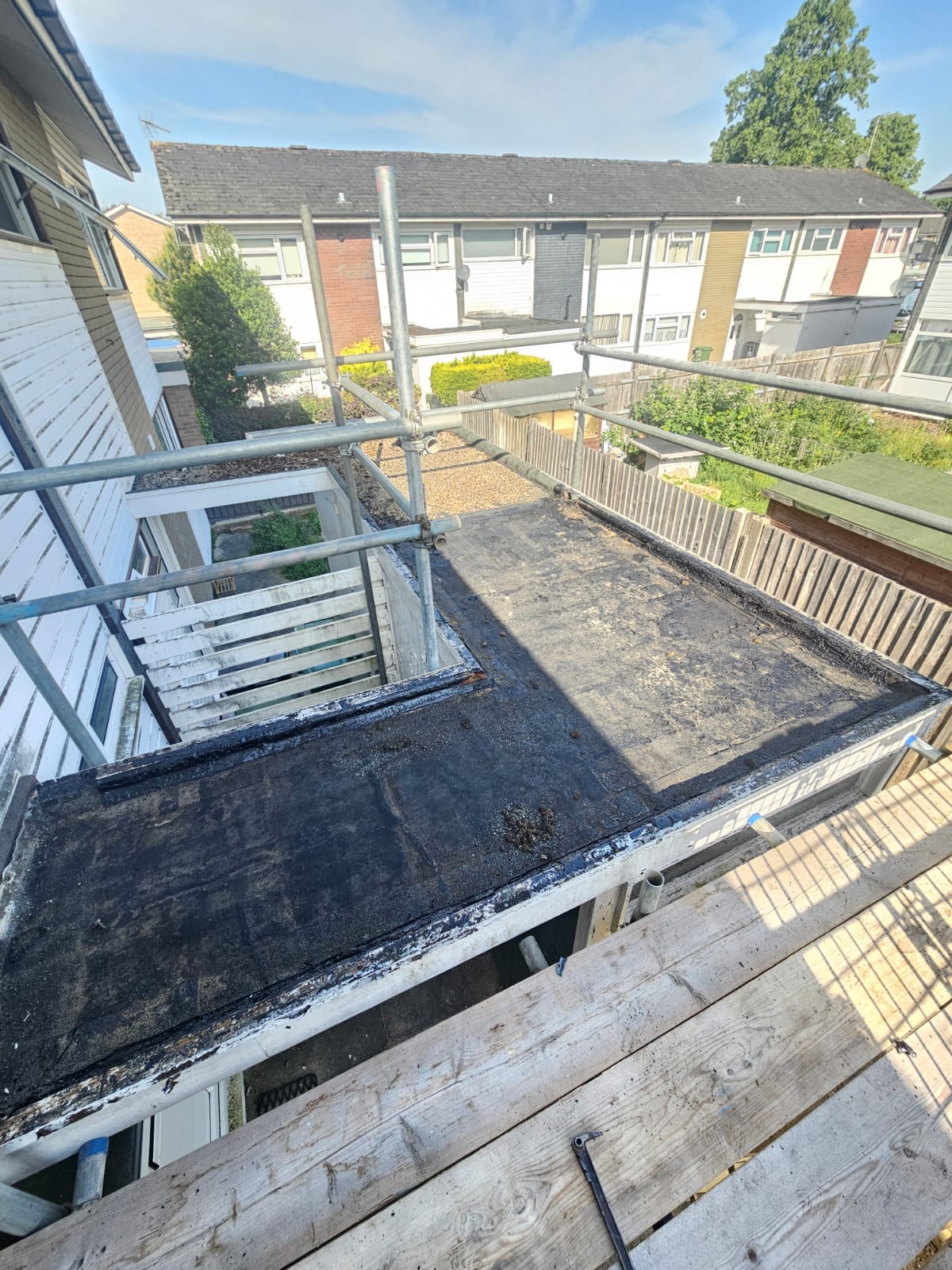 Old deteriorated felt flat roof before replacement