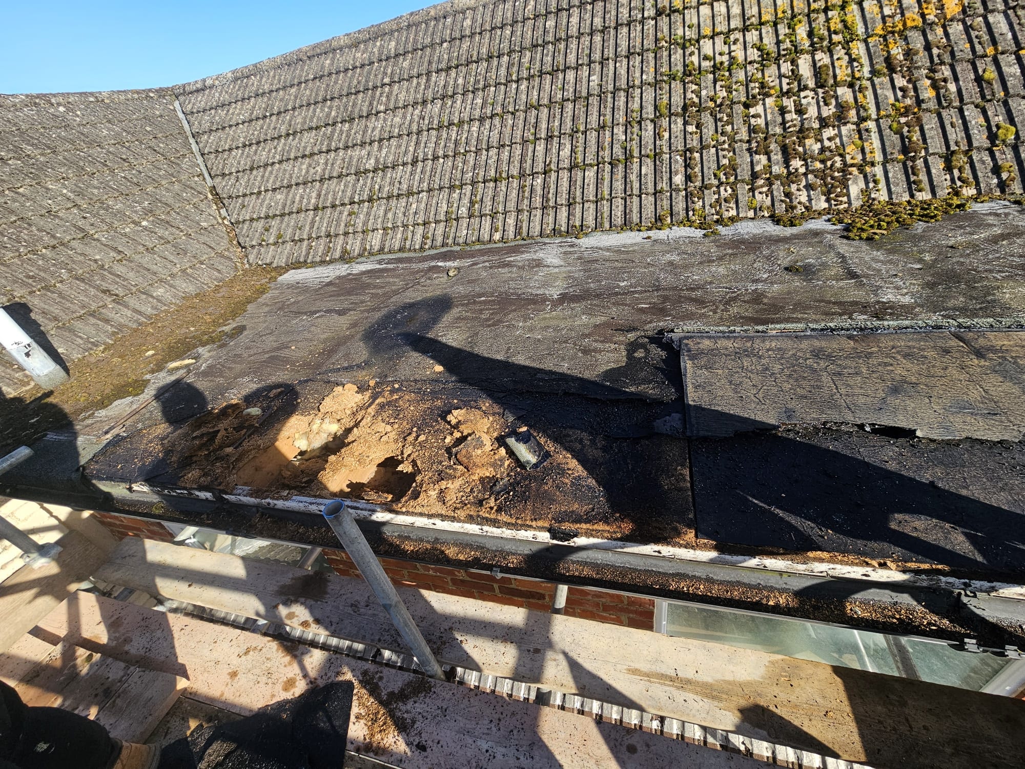 Stripping failed flat roof before replacement