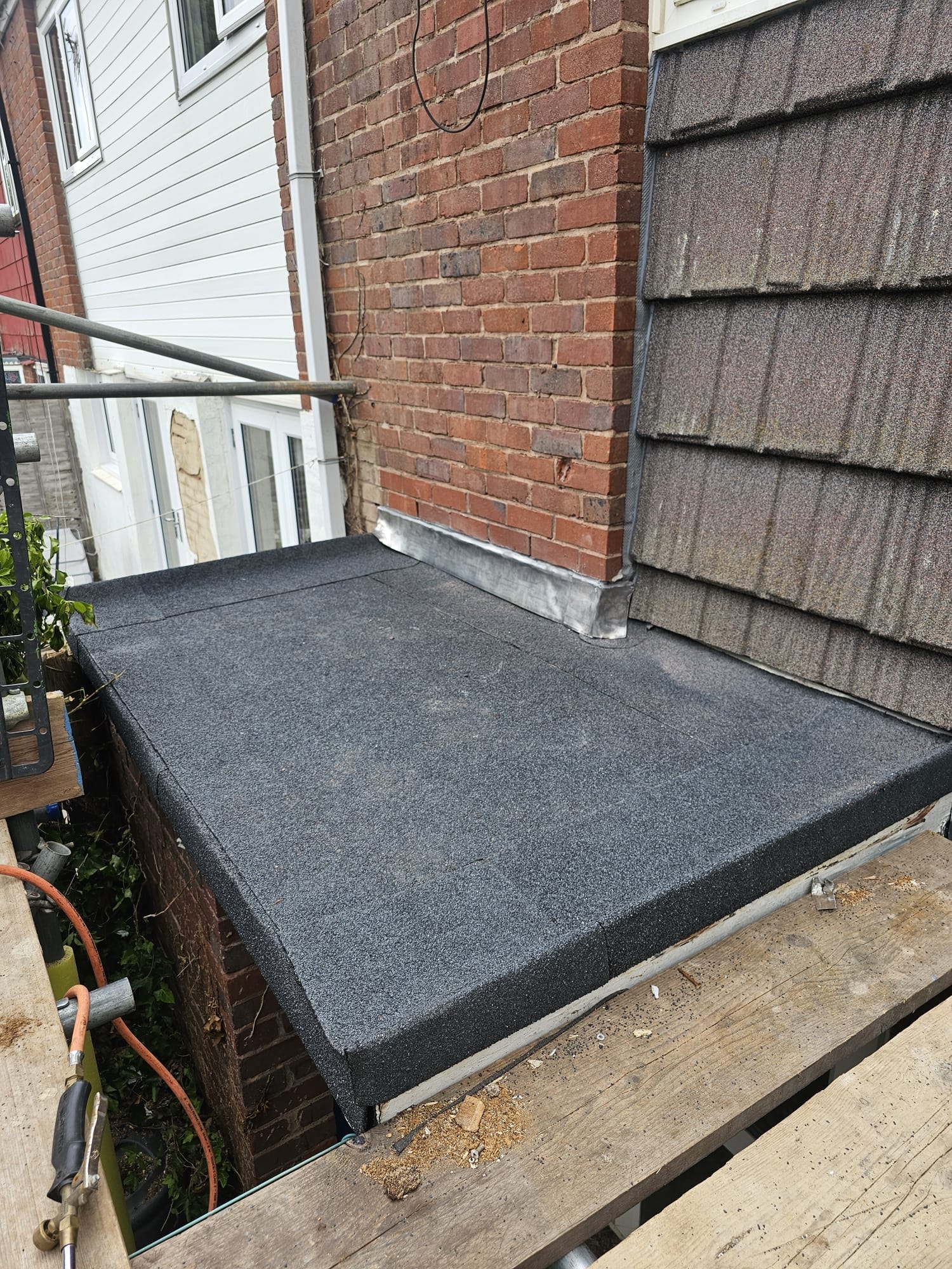 Completed torch-on felt flat roof with lead flashing