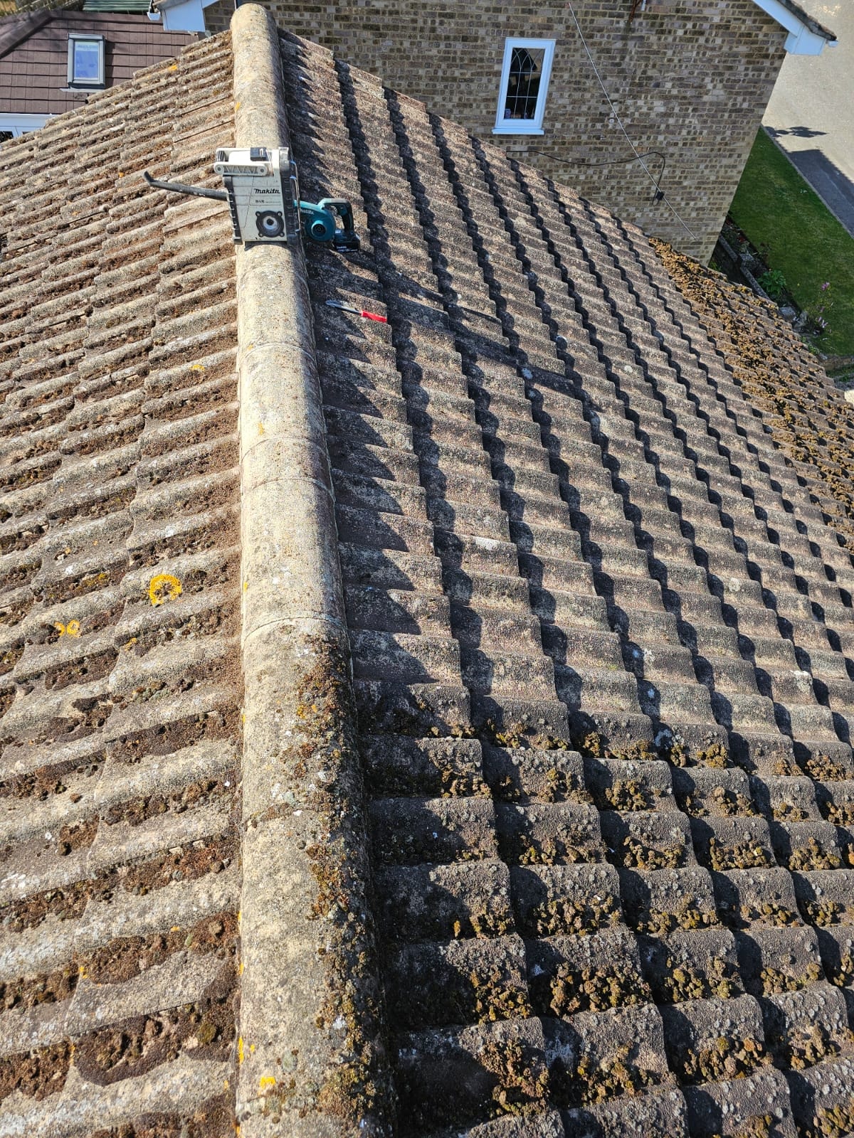 Moss removal equipment on ridge tiles